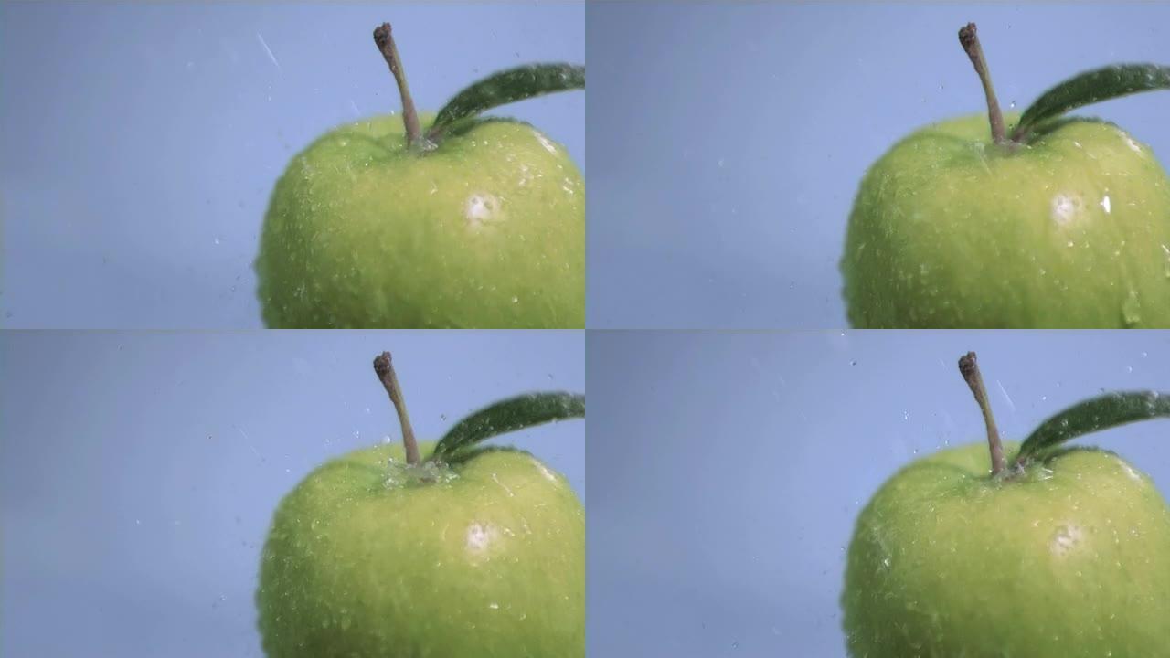超级慢动作中的水落在苹果上