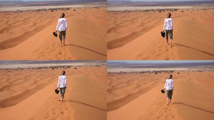 女人赤脚穿过沙漠