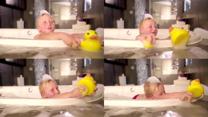 小男孩在泡泡浴中玩橡皮鸭