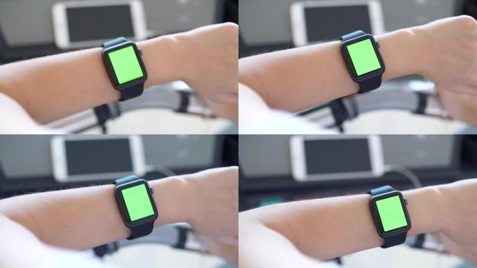 使用智能手表的特写，绿屏