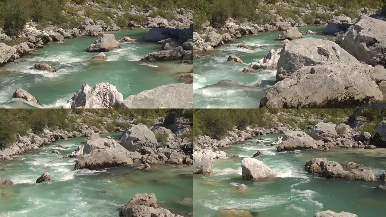空中，特写: 惊人的翡翠保持河流在大石头之间奔跑