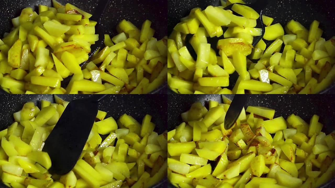 慢动作在煎锅中用沸腾的油煎炸土豆