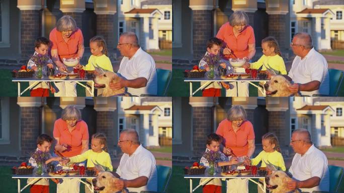 孩子们帮助祖母摆放野餐桌