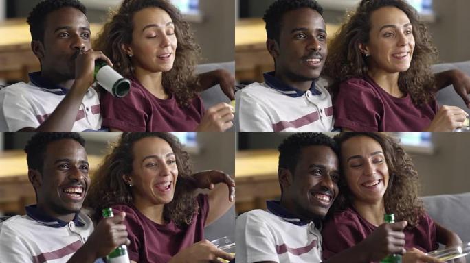 非洲男子与女友在电视上看足球