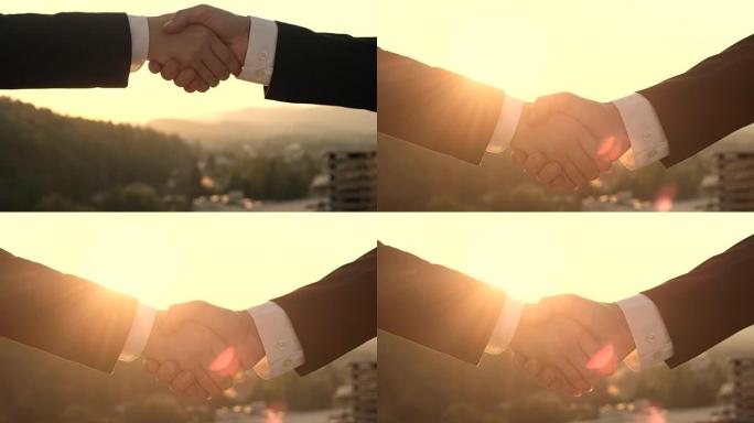特写: 企业家在日落时握手，这是良好伙伴关系的标志