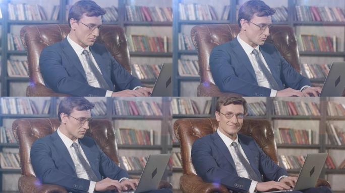 成功黑客的慢动作肖像，戴着眼镜，笔记本电脑坐在椅子上。商人系列。