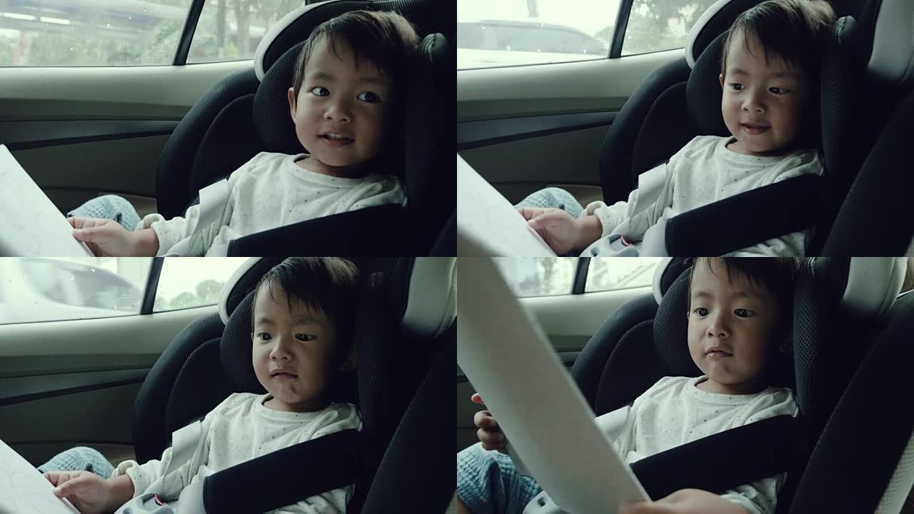 亚洲男婴在他的儿童安全汽车座椅