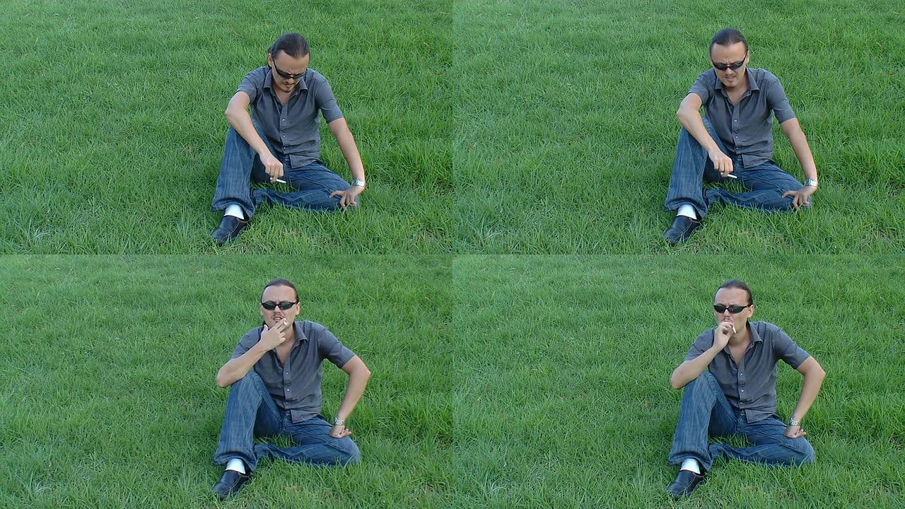 一个年轻人在绿色的草坪上抽烟