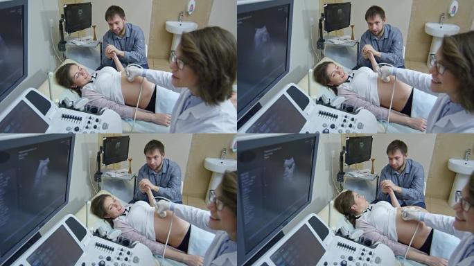 男子在超声波测试期间支持怀孕的妻子