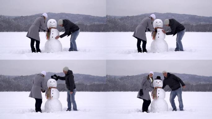 年轻夫妇堆雪人