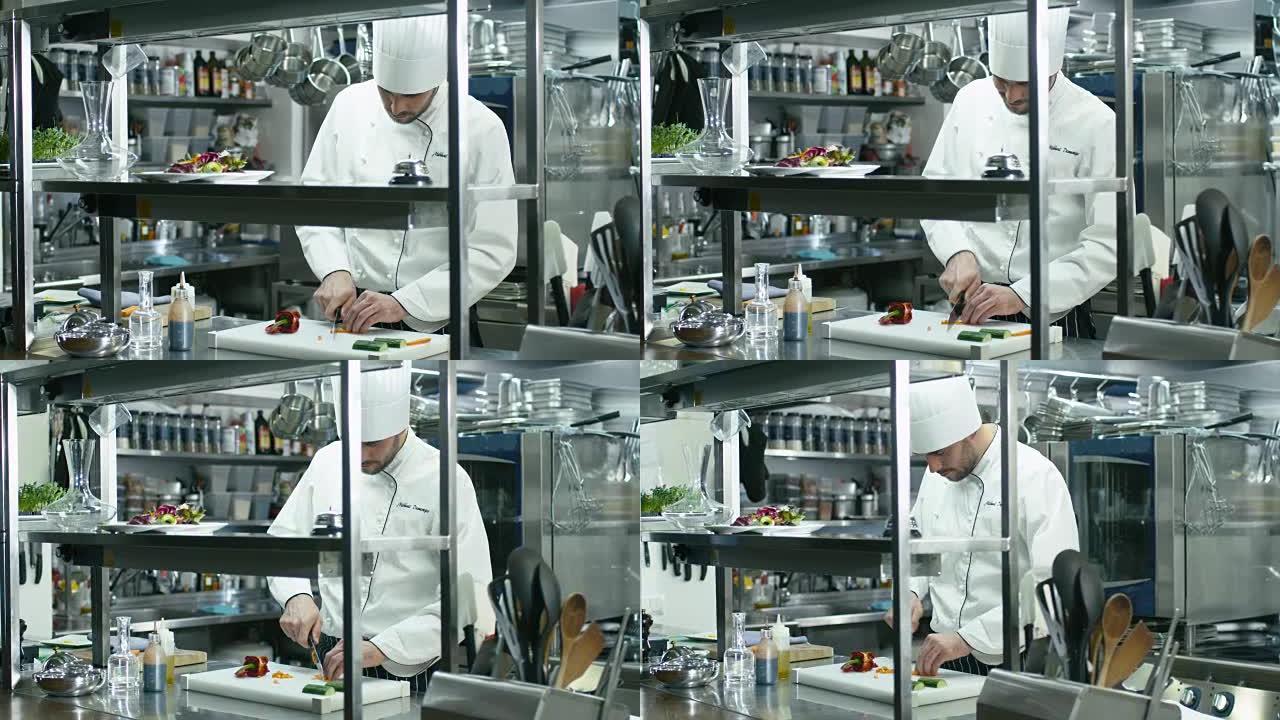 商业厨房的专业厨师正在切绿色蔬菜。