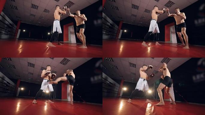两名mma战士在拳击馆锻炼。慢动作