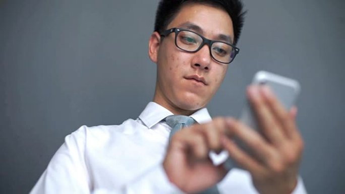 亚洲男子使用智能手机，他是社交瘾君子