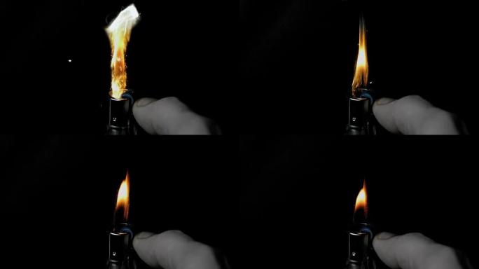 手在黑色背景上使用打火机，带有火花