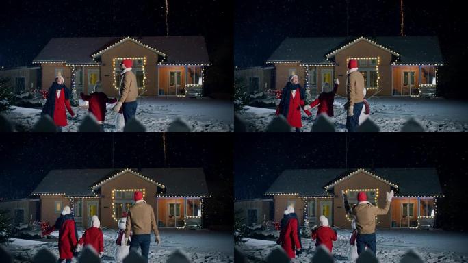 新年快乐，年轻的三口之家站在前院观看美丽的烟花。傍晚，当下雪时，父亲，母亲和可爱的小女儿惊奇地抬头。