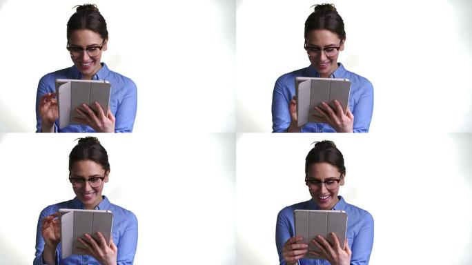 在白色背景下使用数字平板电脑拍摄女人的照片