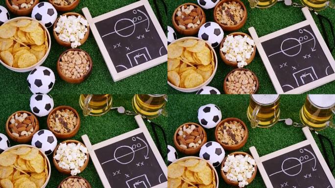一碗零食，足球，啤酒，哨子和人造草上的石板4k
