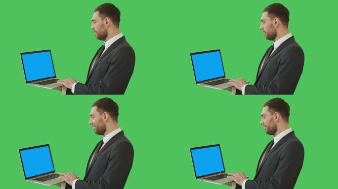一个英俊的商人拿着笔记本电脑和触摸板的中等镜头。我们看到笔记本的蓝屏，都是在绿屏背景上拍摄的。