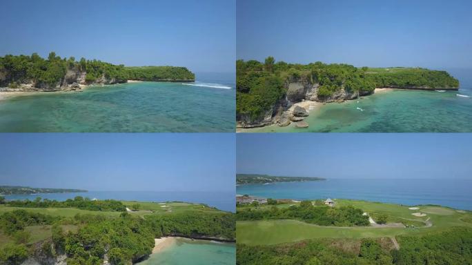 航拍:奢华的高尔夫球场坐落在海面上的悬崖峭壁上，上面挤满了冲浪者
