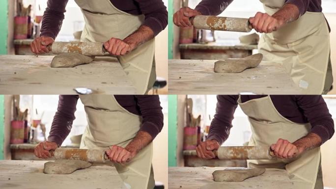 带有rolling面杖的男性陶工成型粘土