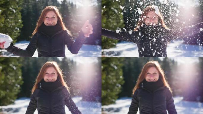 年轻女子向空中扔雪