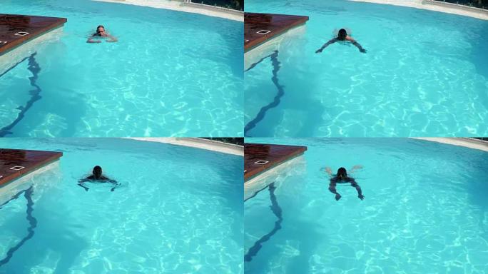 男子在游泳池游泳