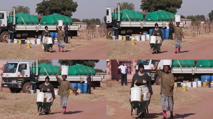 两名非洲妇女从油轮上取水，然后走回自己的家