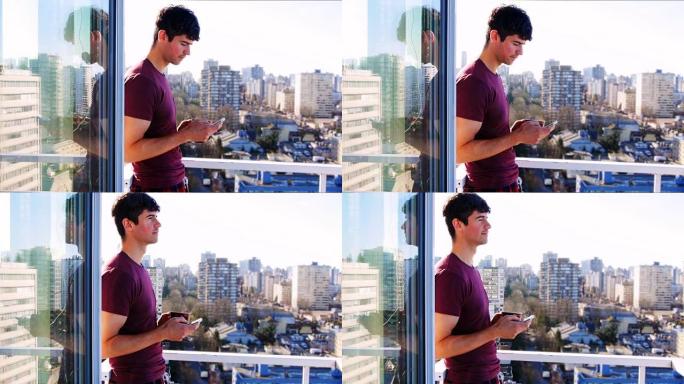 男子在4k阳台喝咖啡时使用手机