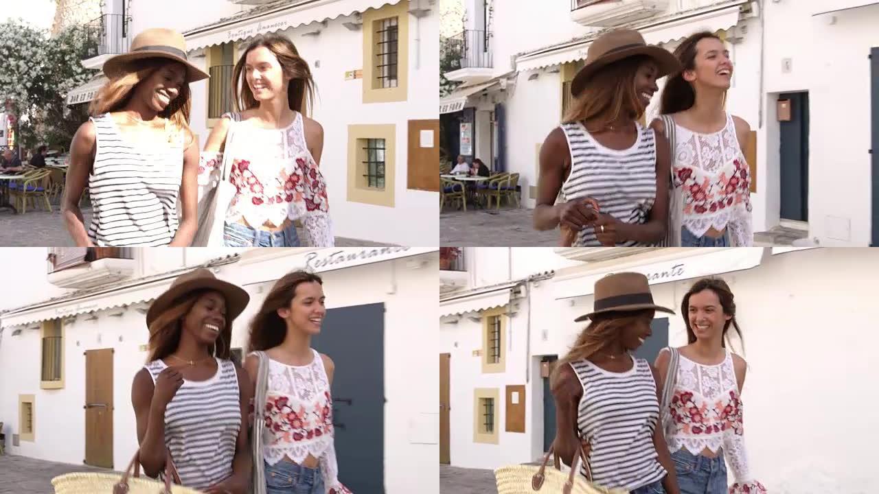 在R3D上拍摄的两名女性朋友在西班牙伊比沙岛的街道上行走