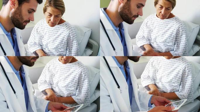 男性医生在数字平板电脑上与女性患者讨论医疗报告