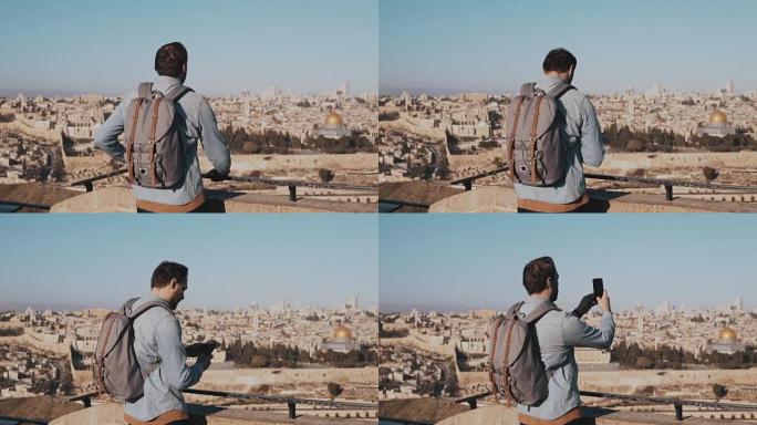 男子在以色列，耶路撒冷拍摄智能手机照片。欧洲游客男性享有古老的风景。游。慢动作