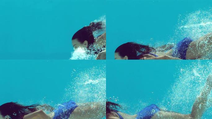 穿着蓝色泳衣的女人在水下游泳