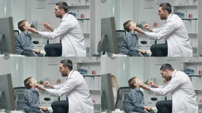 男医生检查年轻男孩的喉咙。护士在后台很忙。