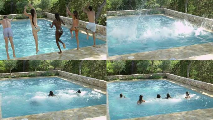 一群度假的朋友跳进室外游泳池