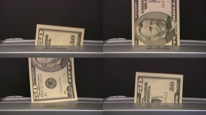 美元钞票被碎纸机撕碎。通货资金