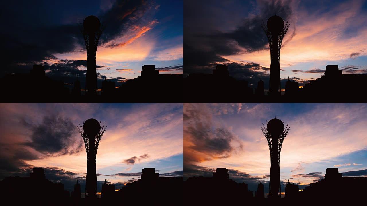 在美丽的日落时，哈萨克斯坦首都阿斯塔纳的剪影Bayterek塔的延时