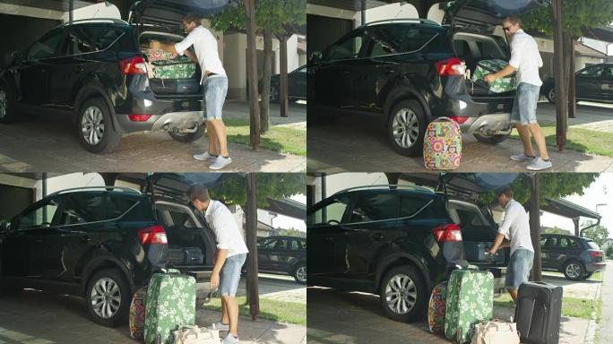 镜头耀斑: 快乐的人从大型黑色SUV中取出他的大旅行包。