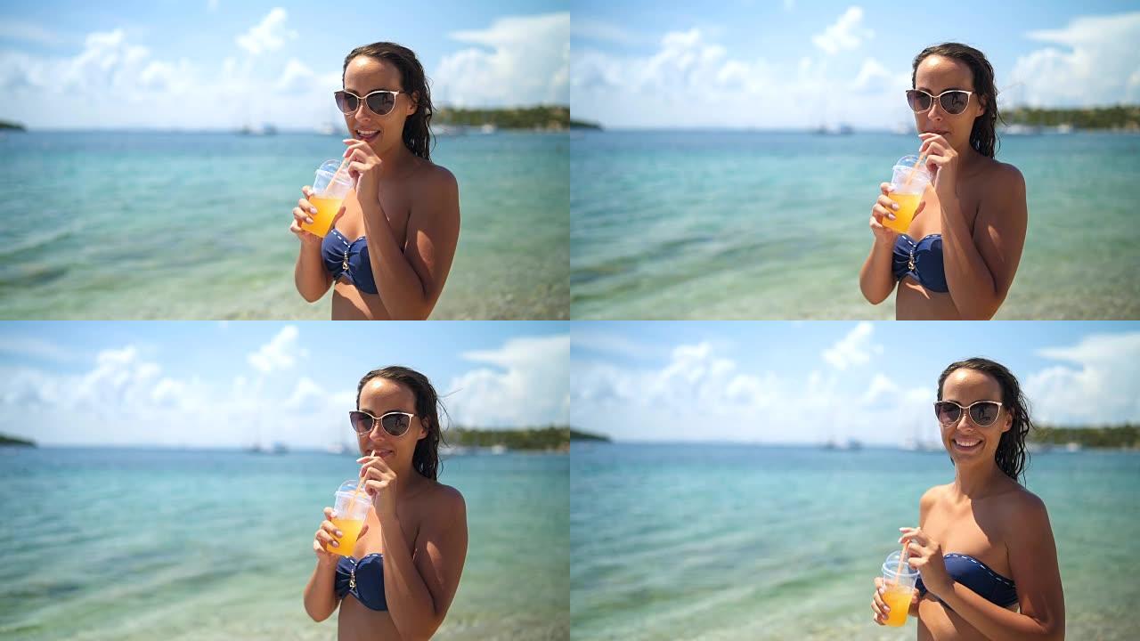 微笑的女人在海边喝新鲜果汁