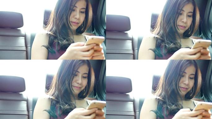 出租车上的年轻女子在智能手机上上网