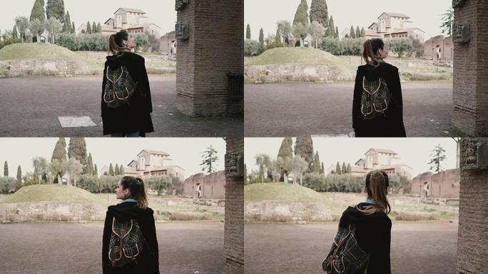 漂亮的年轻女孩正在意大利罗马散步，看着一件古董。游客正在探索古老的遗迹