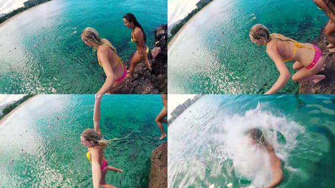 POV GOPRO高清慢动作组比基尼女孩从悬崖跳到夏威夷的海洋。