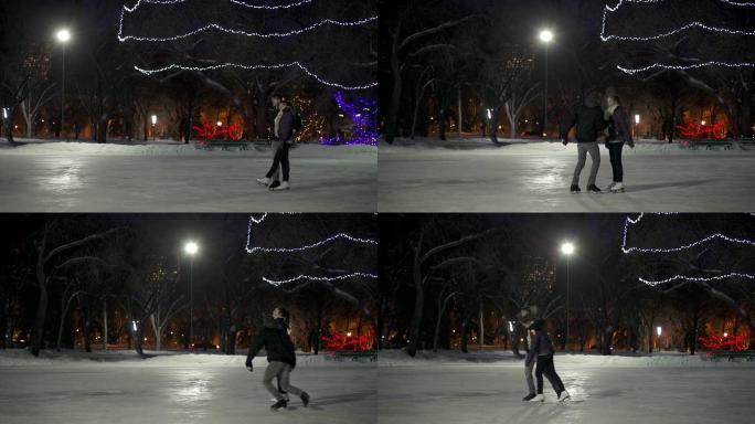 这对情侣在一个冬天的晚上有滑冰约会。