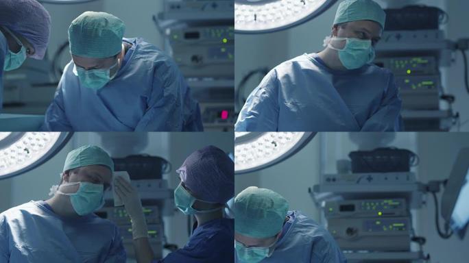 现代手术室外科手术中护士擦去医生额头上的汗水