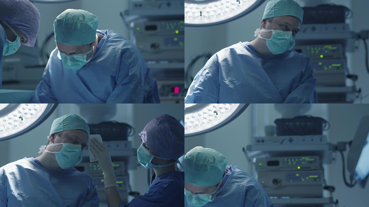 现代手术室外科手术中护士擦去医生额头上的汗水