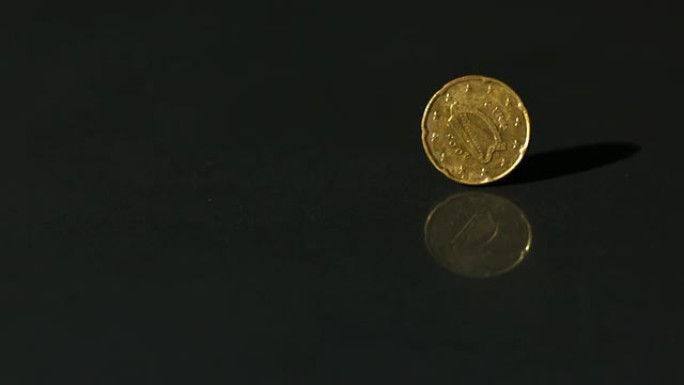 欧元硬币在黑色表面上旋转