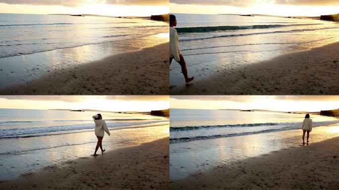 日落时沿着水面行走的女人