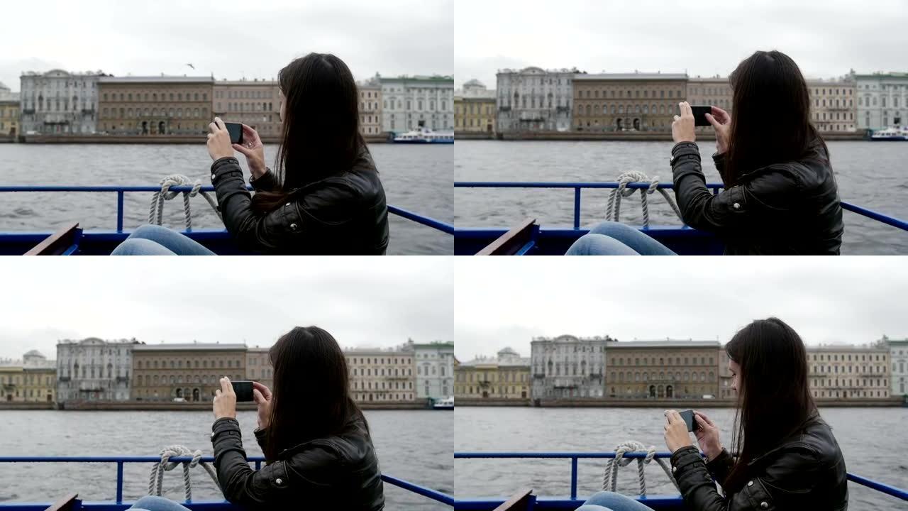 女孩坐在河边公共汽车上，在河边码头上拍照。一只海鸥飞来飞去，慢速mo