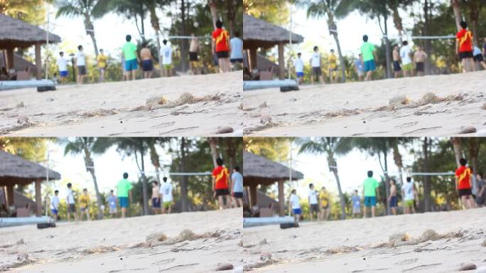 侧视图在海滩上打排球