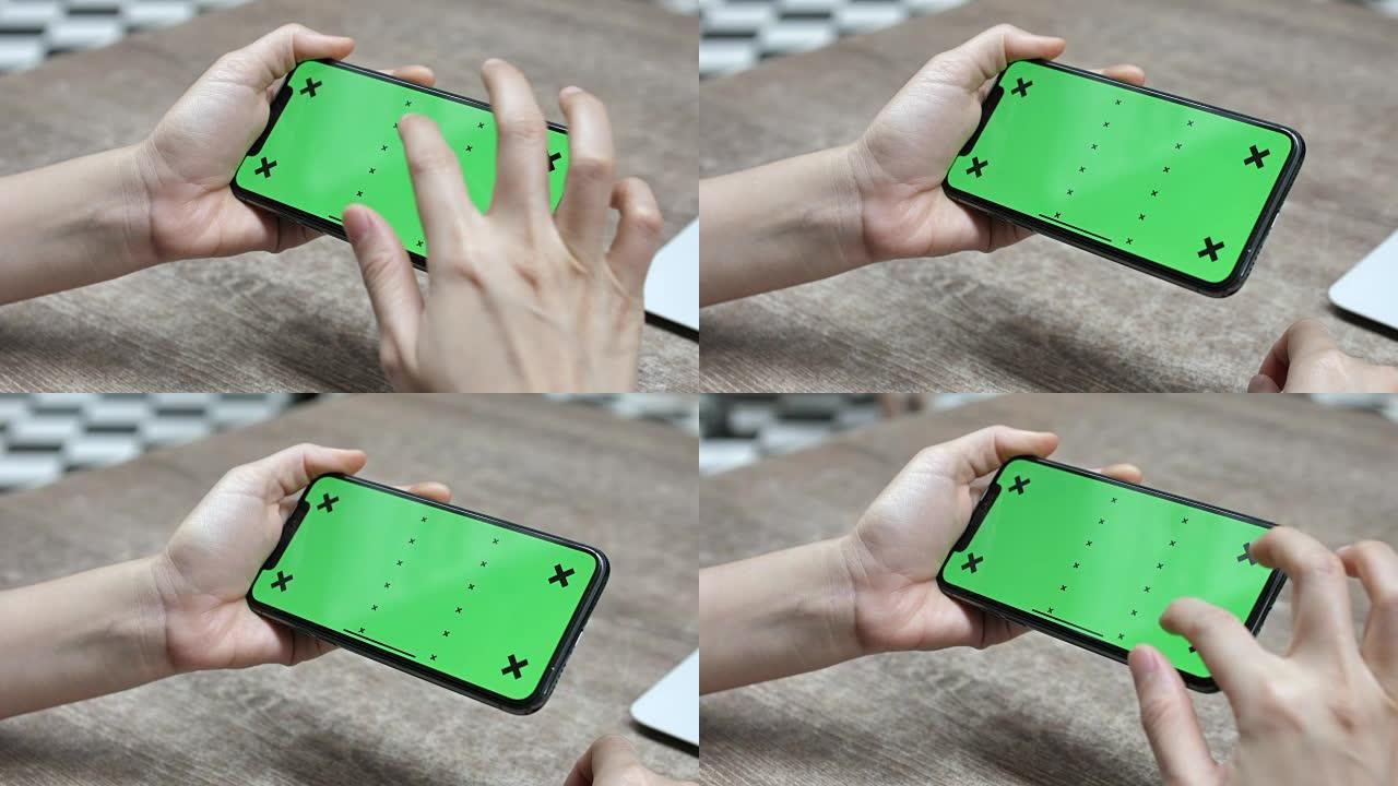 使用智能手机绿屏，特写，水平