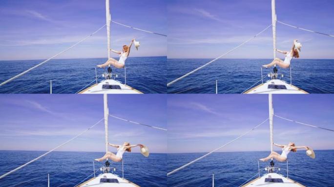 WS快乐的女人在帆船的船头上享受海风